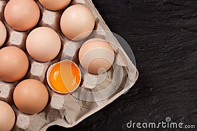 Eggs in a tray on a dark background with copy space for your text. Top view Stock Photo