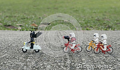 Ego starwars troopers riding bicycle chasing lego batman Editorial Stock Photo