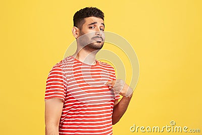 Egocentric selfish man pointing finger at himself, looking with pride and arrogance, feeling self-important and famous Stock Photo