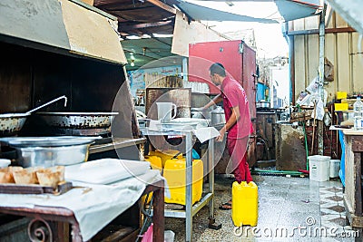 Egyptian fish market worker preparing street food Editorial Stock Photo