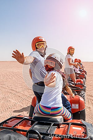 Egypt / Hurghada - 01/05/2016: A group of happy people ride quad bikes in the desert Editorial Stock Photo