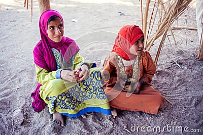 Egypt, Hurghada, 12 may 2019, two little girls sitting on the ground in the beduin village Editorial Stock Photo