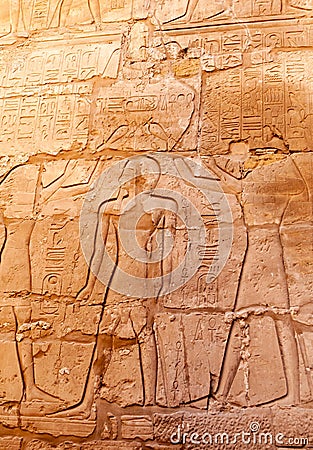 EGYPT, LUXOR - MARCH 01, 2019: ancient Egyptian hieroglyphs, drawings and inscriptions on the walls and columns in the temple of Editorial Stock Photo