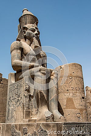 Egypt Luxor Temple. granite Statue of Ramesses II seated in front of columns Editorial Stock Photo