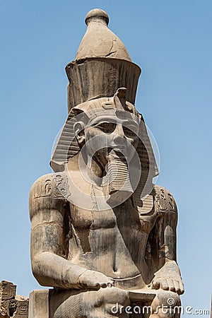 Egypt Luxor Temple. granite Statue of Ramesses II seated in front of columns Editorial Stock Photo