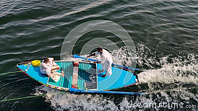 Egyptian boys selling handmade cloth while sailing on boat Editorial Stock Photo