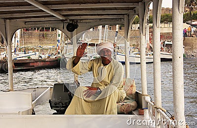 Egyptian captain driving his boat on the Nile river, Luxor Editorial Stock Photo