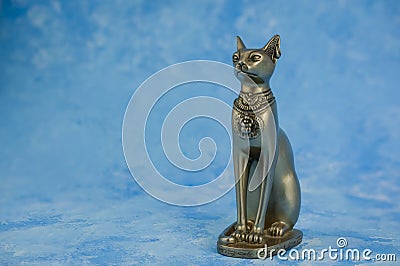 Egyptian cat Bast or Bastet, solar and war goddess, isolated on blue Stock Photo