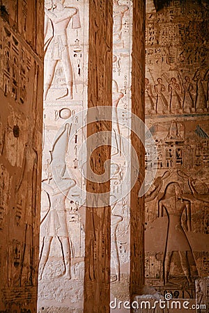 Egyptian figures in columns Stock Photo