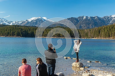 Eibsee, Germany, March 31, 2019: husband taking selfie of his wife for instagram at eibsee Editorial Stock Photo