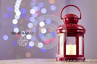 Eid al-Fitr Mubarak Greeting Typography with Bokeh backgound. Arabic lantern on wooden backgound Stock Photo