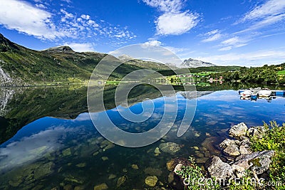 Eidsvatnet lake surrounded by hills reflecting on the water under the sunlight in Norway Stock Photo