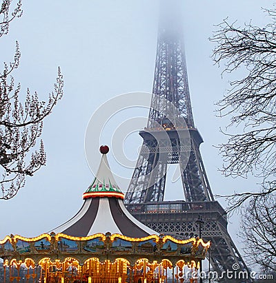 Eiffel Tower and antique carousel as seen at night in Paris, France Editorial Stock Photo