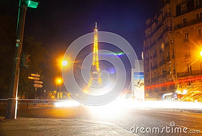 Eiffel Tower brightly illuminated at dusk in Paris Editorial Stock Photo