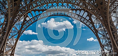 Eiffel tower closeup arch frame over blue cloudy sky in Paris France Stock Photo