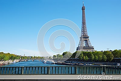 Eiffel tower and empty sidewalk bridge on Seine river in Paris Stock Photo