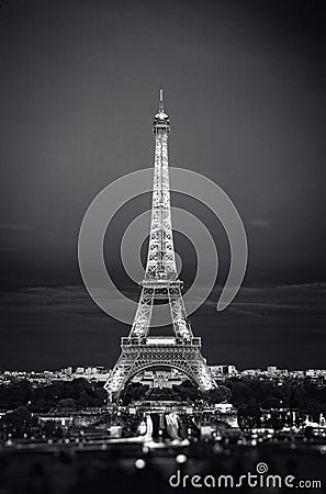 Eiffel Tower in night. Famous historical landmark on the quay of a river Seine. Romantic, tourist, architecture symbol Editorial Stock Photo