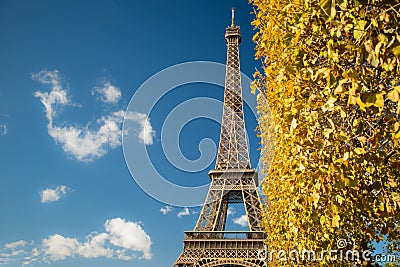 Eiffel Tower over blue sky and fall leaves Stock Photo