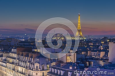 Eiffel tower over the crowded roofs Editorial Stock Photo