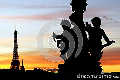 Eiffel tower and Alexandre III bridge sculptures silhouettes during a Parisian sunset Stock Photo