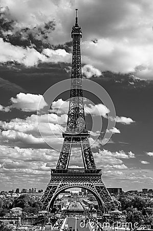 Eiffel Tower poking into the cloudy sky Stock Photo