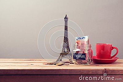Eiffel Tower souvenir and money box on wooden table. Planning summer vacation, money budget trip Stock Photo