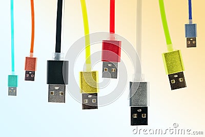 Eight multicolored usb cables hang vertically, on a gradient, tinted background. The family unites. future technologies. Stock Photo