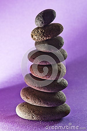 Eight stones in the sand,black-ground purple Stock Photo