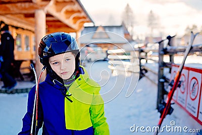 Eight years old boy in helmet on ski slope. Stock Photo