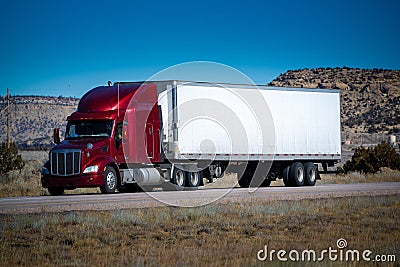 Eighteen wheel big rig tractor with trailer on highway. Trucking industry Stock Photo