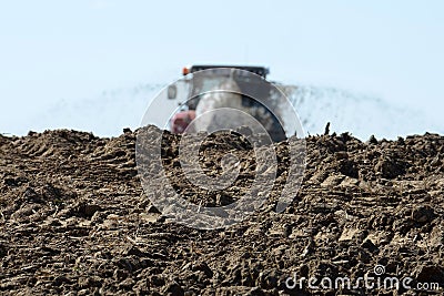 A tractor with a slurry tanker in a field Stock Photo