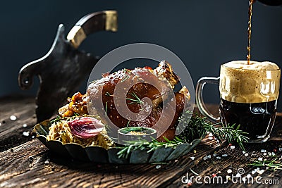 Eisbein with braised sauerkraut, mustard and beer, Oktoberfest, The concept of traditional German cuisine, freeze motion, catering Stock Photo