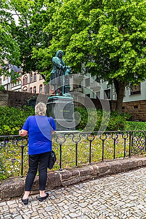 Eisenach, Germany - May 28, 2019: Tourists pose with the statue of J.S. Bach outside the house where the famous composer and Editorial Stock Photo