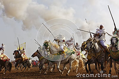 Raditionally dressed Moroccan tribals and horsemen riding the horses and fire the rifles Editorial Stock Photo