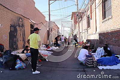 Immigrants staying and sleeping in an alley, waiting to get approved to enter the USA. Title 42. El Paso, Texas, USA Editorial Stock Photo