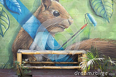 Mural painting in El Tunco with empty bamboo bench. Murals are very popular in El Editorial Stock Photo