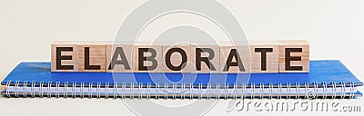 ELABORATE word on wooden cube on blu background Stock Photo