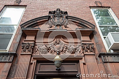 Elaborately carved pediment over an entry door on an old brownstone Stock Photo