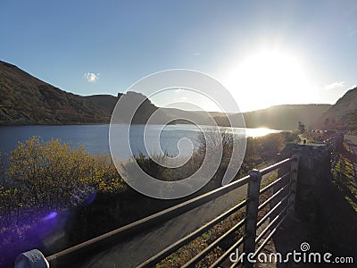 Elan Valley reservoirs, Wales with sun going down in blue skies Stock Photo
