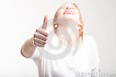 Elated excited woman giving a thumbs up Stock Photo