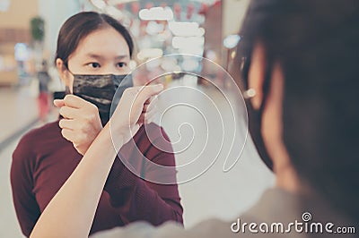 Two women friends meet in public with bare hands Stock Photo