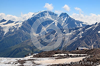 Elbrus, Caucasus, Russia - August 2019: glacier, clouds and mountains, view from Garabashi station of cable car. Editorial Stock Photo