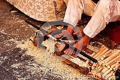 Craftsman carving wood at a market stall Editorial Stock Photo