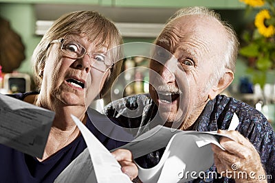 Elder Couple with Bills Stock Photo