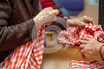 Elder hands, folding napkins Stock Photo
