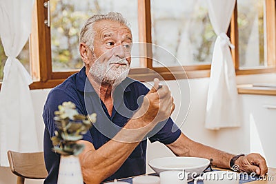 Elder loss of appetite boring food bad taste unhappy when eating meal during stay home Stock Photo