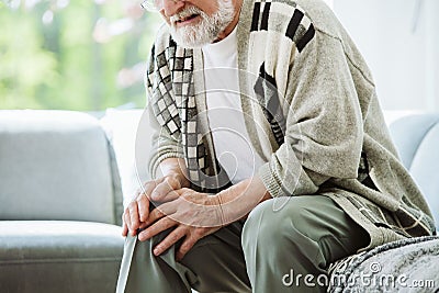 Man having problems with knee, real photo Stock Photo