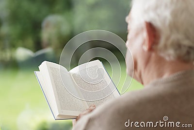 Elder man reading book Stock Photo