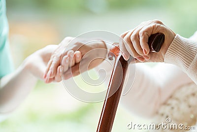 Elder person using walking cane Stock Photo