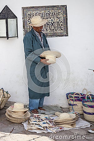 Elder street vendor selling handmade souvenirs Editorial Stock Photo